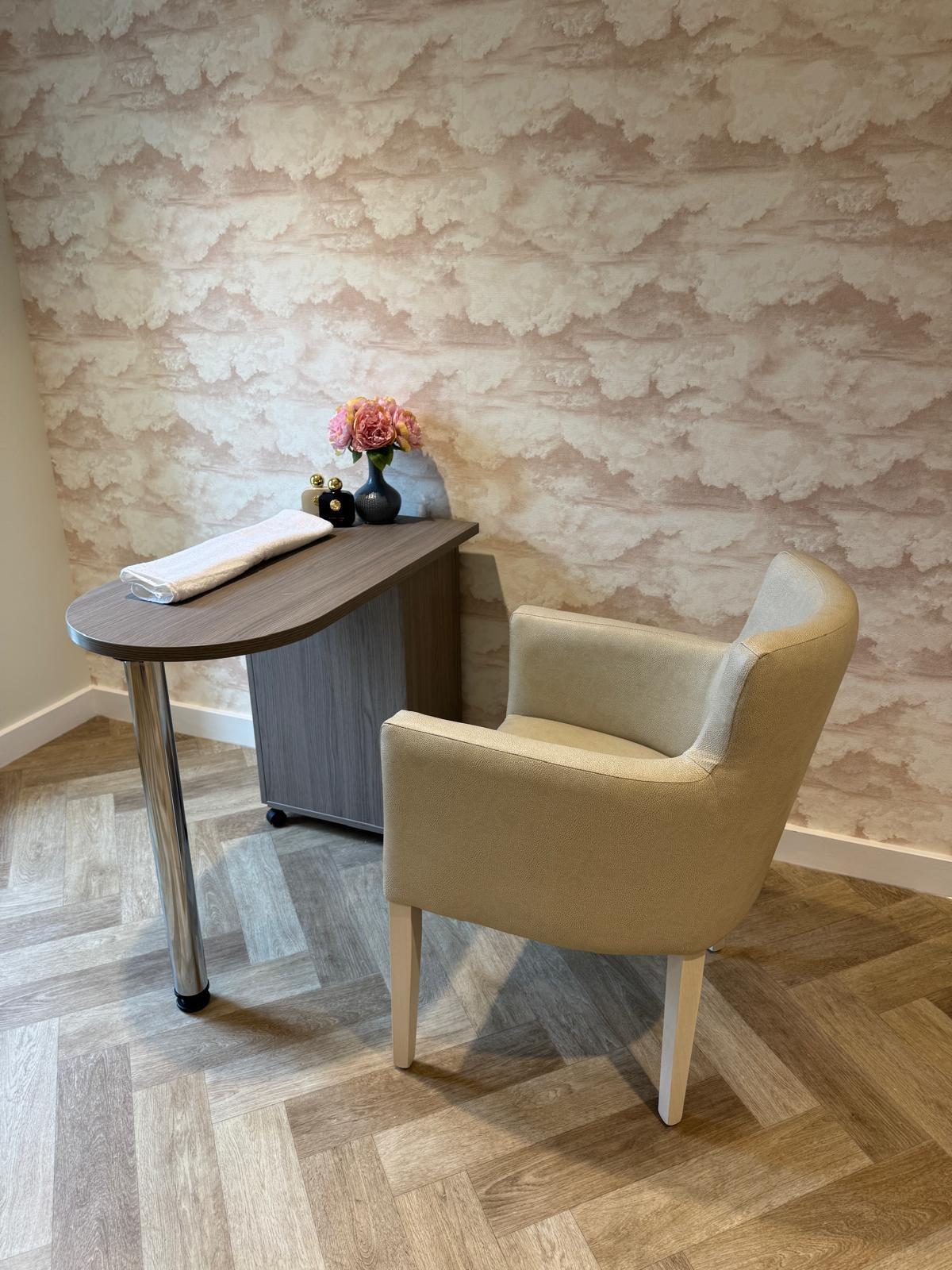 cream leather chair by a wooden table in a nail salon