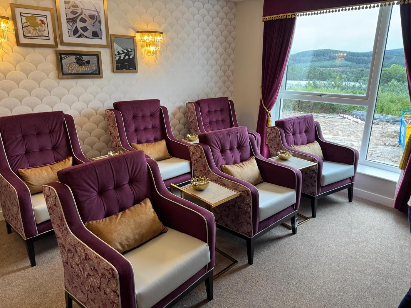 purple chairs next to each other in a cinema room