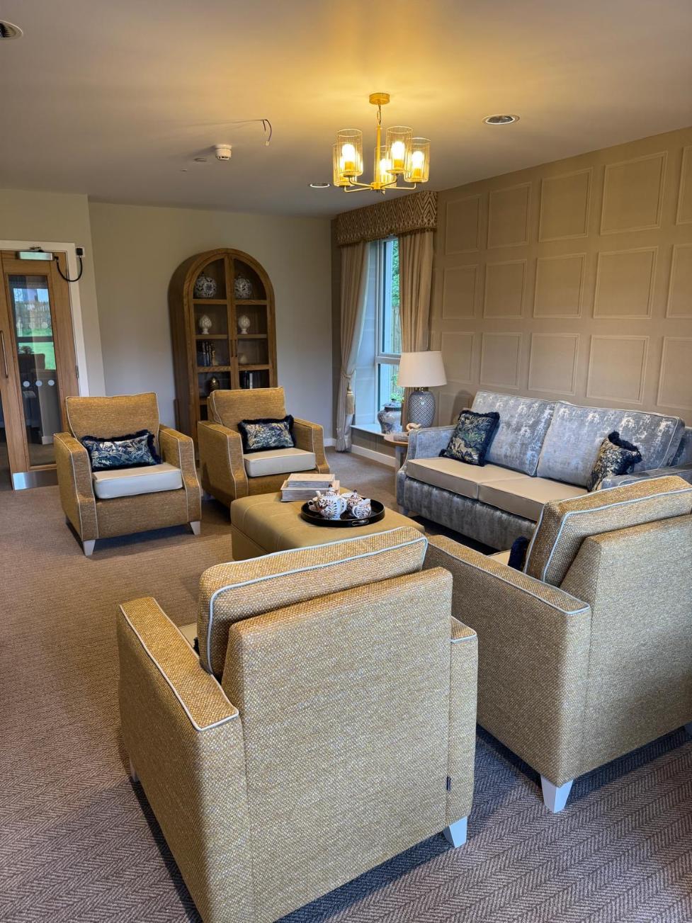 yellows chairs and sofas facing each other in a lounge area